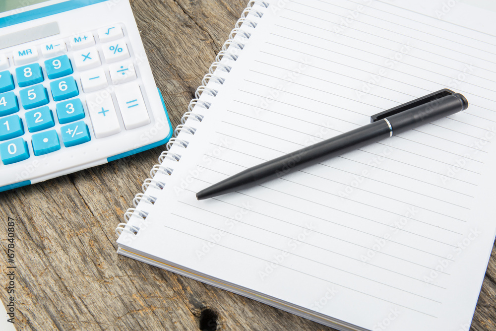 note paper,pen and calculator on wooden table note paper,pen and calculator on wooden table
