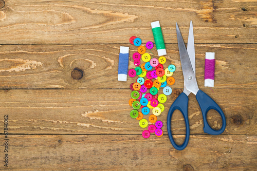 Sewing buttons, scissors and rolls of thread