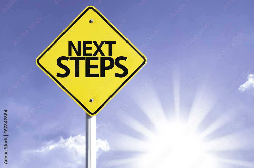 Next Steps road sign with sun background