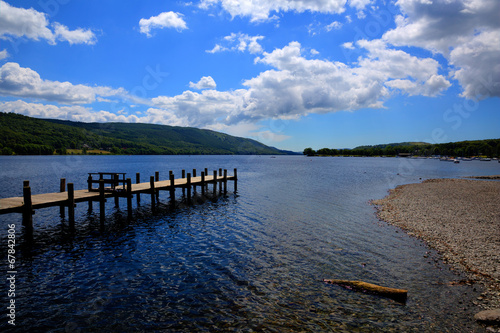 Coniston Water Lake District England uk with jetty and blue sky