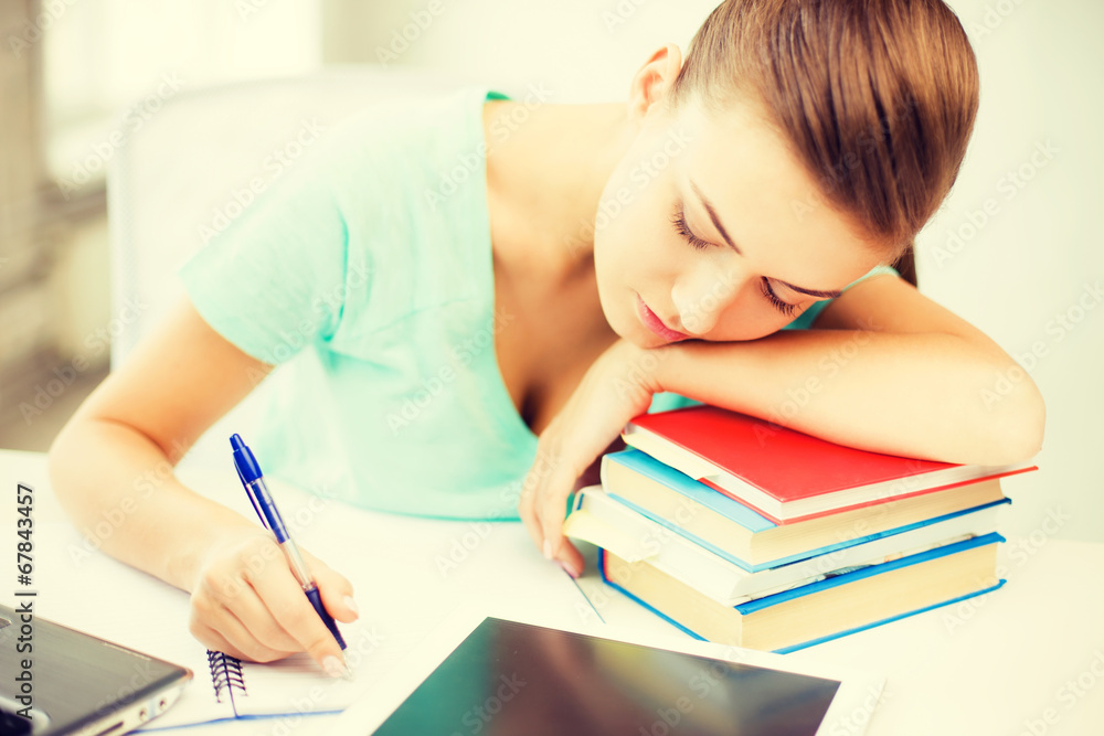 tired student sleeping on stock of books tired student sleeping on stock of books