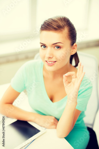 girl with tablet pc showing ok gesture