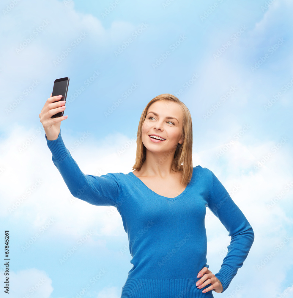 woman taking self picture with smartphone camera woman taking self picture with smartphone camera
