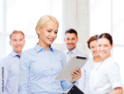 smiling woman looking at tablet pc computer