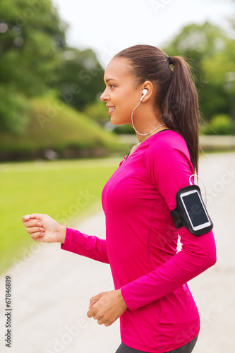 smiling young woman running outdoors © Syda Productions