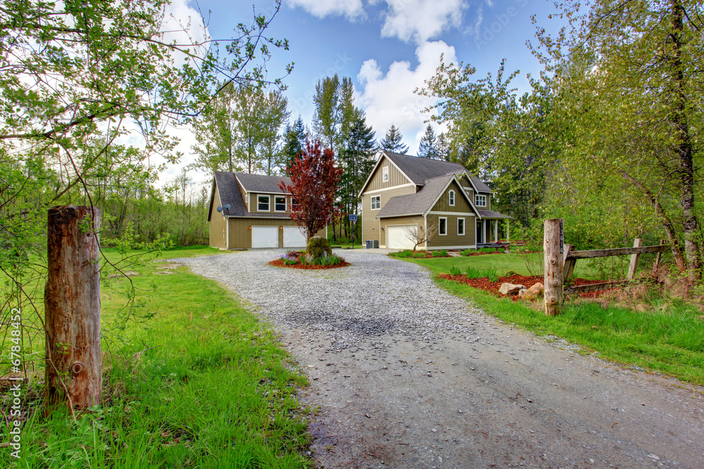 Countryside house exterior. View of entrance and gravel driveway Countryside house exterior. View of entrance and gravel driveway