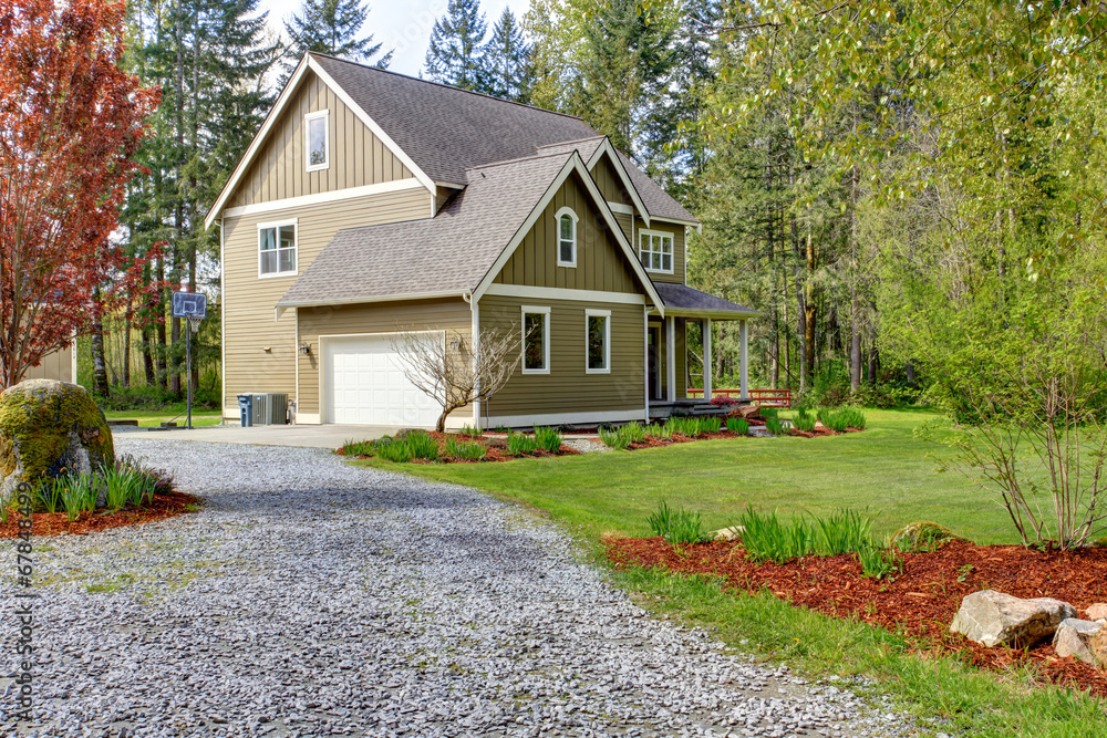 Countryside house exterior. View of entrance and gravel driveway Countryside house exterior. View of entrance and gravel driveway