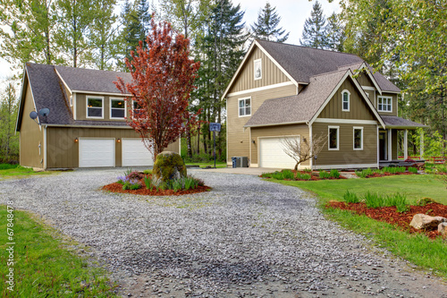 Countryside house exterior. View of entrance and gravel driveway