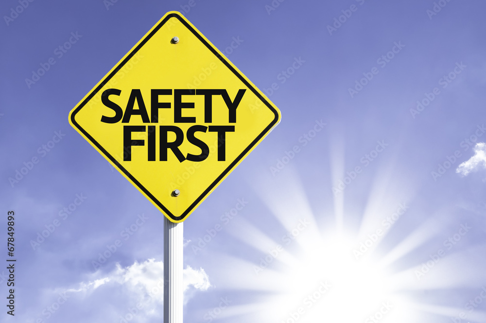 Safety First road sign with sun background Safety First road sign with sun background
