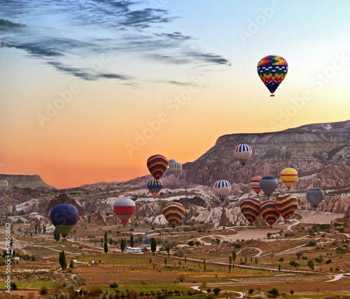 Balloons Hot air balloon flying mountain valley Göreme National Park and the Rock Sites of Cappadocia Turkey