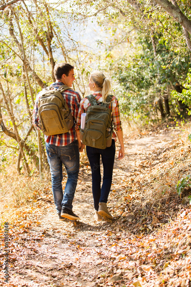 young couple walking in autumn forest young couple walking in autumn forest