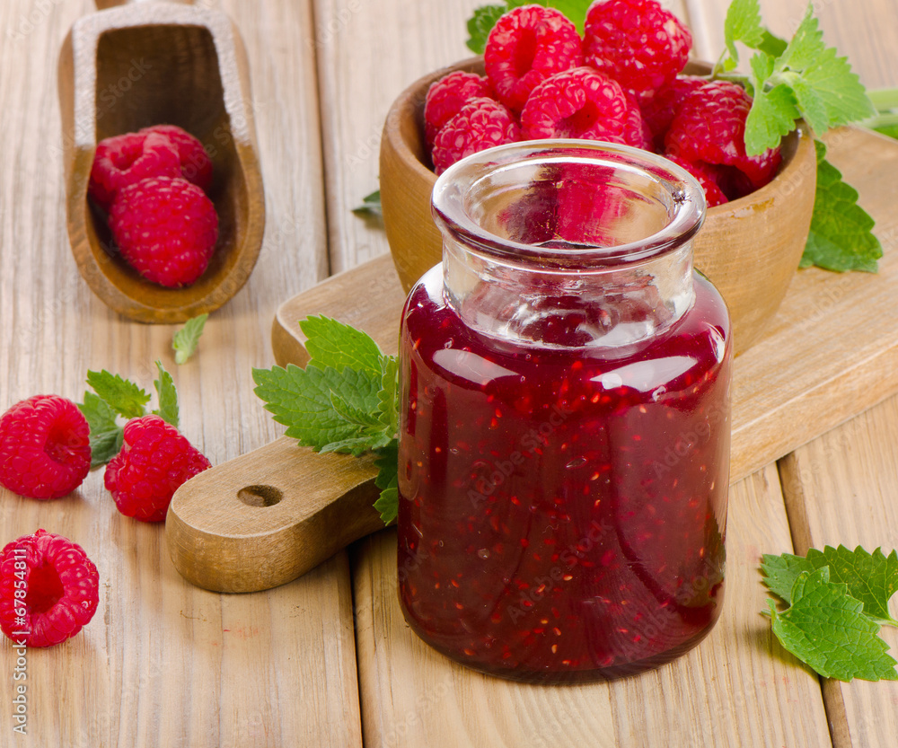 Glass jar of jam with fresh raspberries Glass jar of jam with fresh raspberries