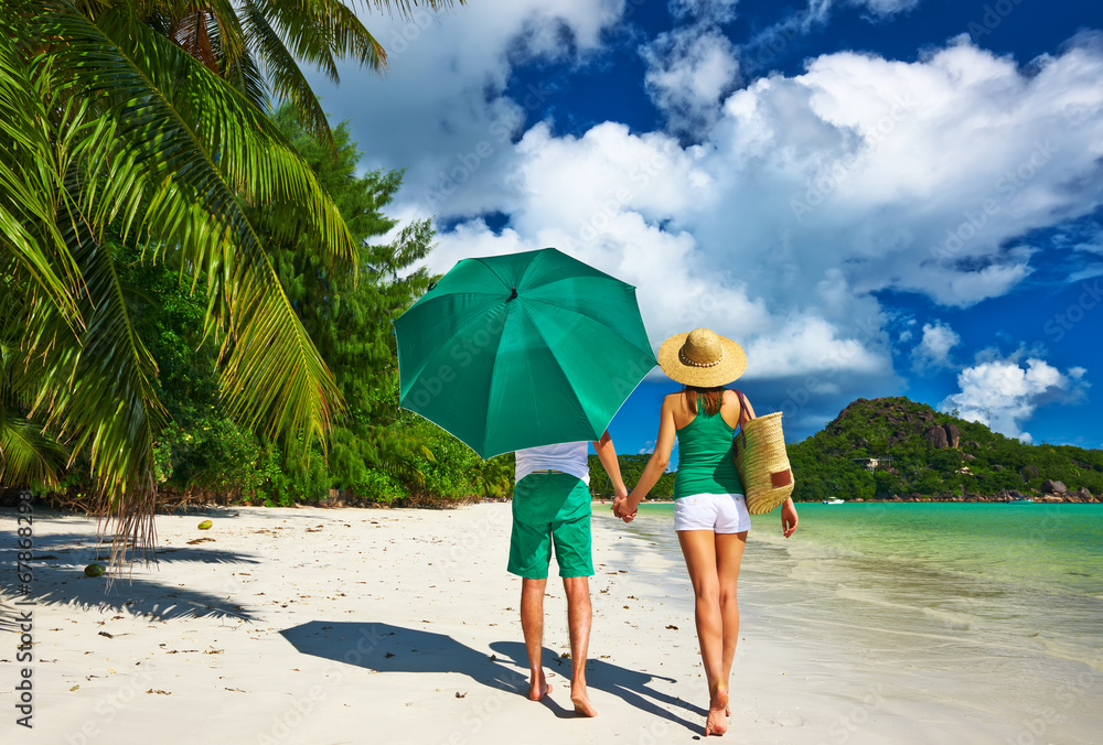 Couple in green on a beach at Seychelles Couple in green on a beach at Seychelles