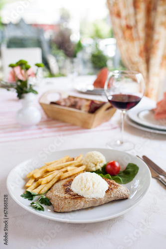 Grilled steak, French fries and vegetables