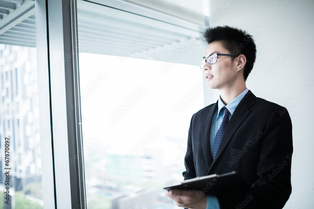 happy young business man work in modern office happy young business man work in modern office
