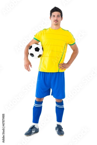 Football player in yellow holding the ball