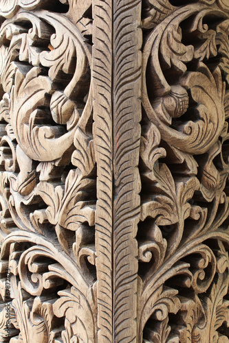 Detail of a wood panel decoration with carved flower