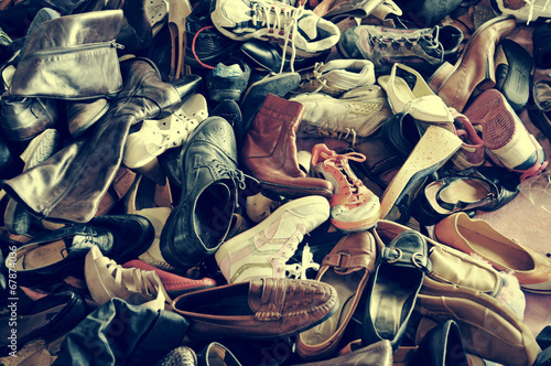 second hand shoes in a flea market, with a retro filter effect