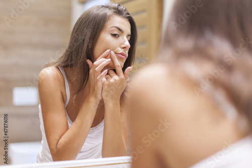 Young woman has problems with skin on the face