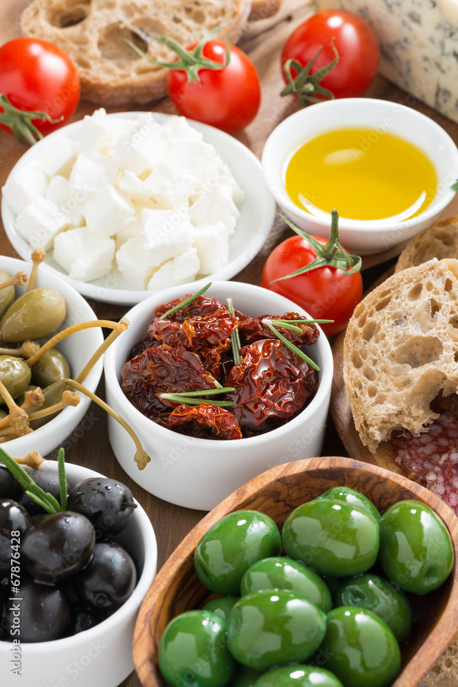 assorted Italian antipasti - olives, pickles and bread, top view