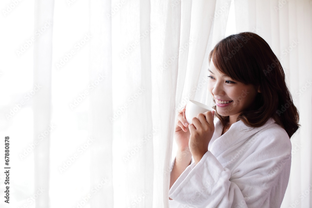 attractive woman holding a cup of coffee, smiling. attractive woman holding a cup of coffee, smiling.