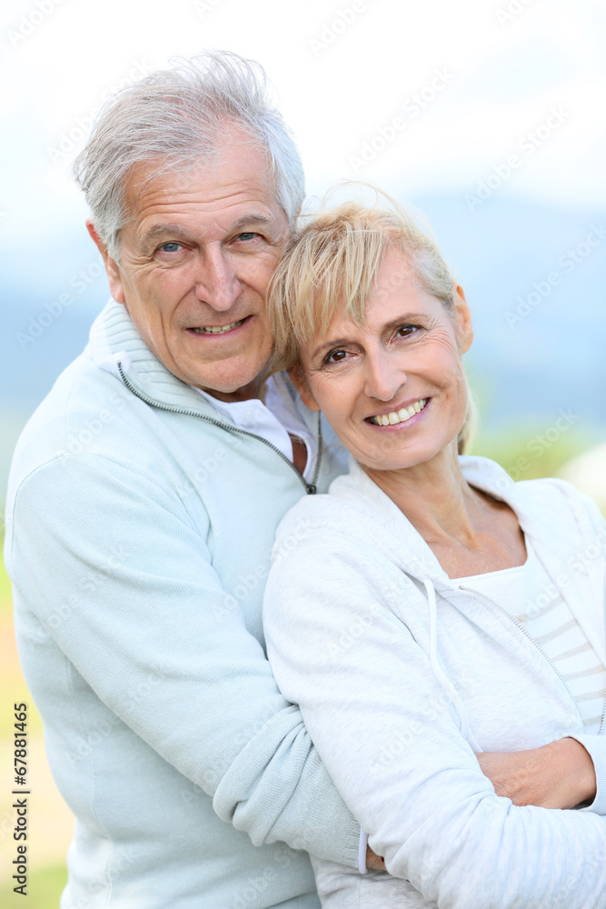 Portrait of cheerful senior couple embracing each other