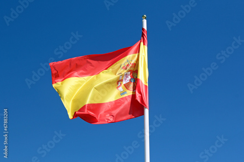 spanish flag against blue sky