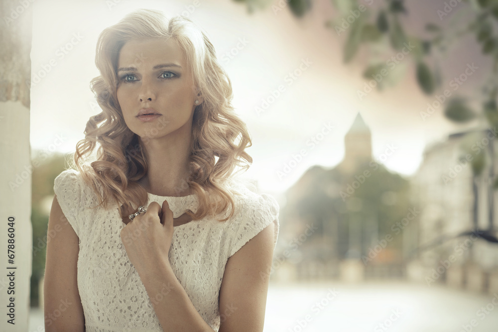 Blond lady with curly hairstyle posing outdoor - obrazy, fototapety, plakaty 
