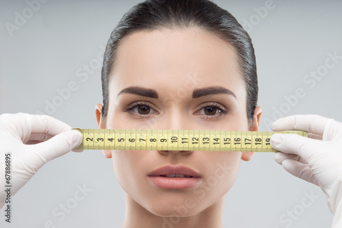 Woman head being measured by beautician hands