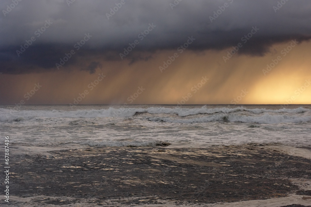 Sea storm at sunset