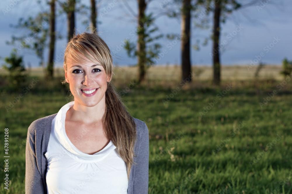 Portrait of young woman smiling outdoors
