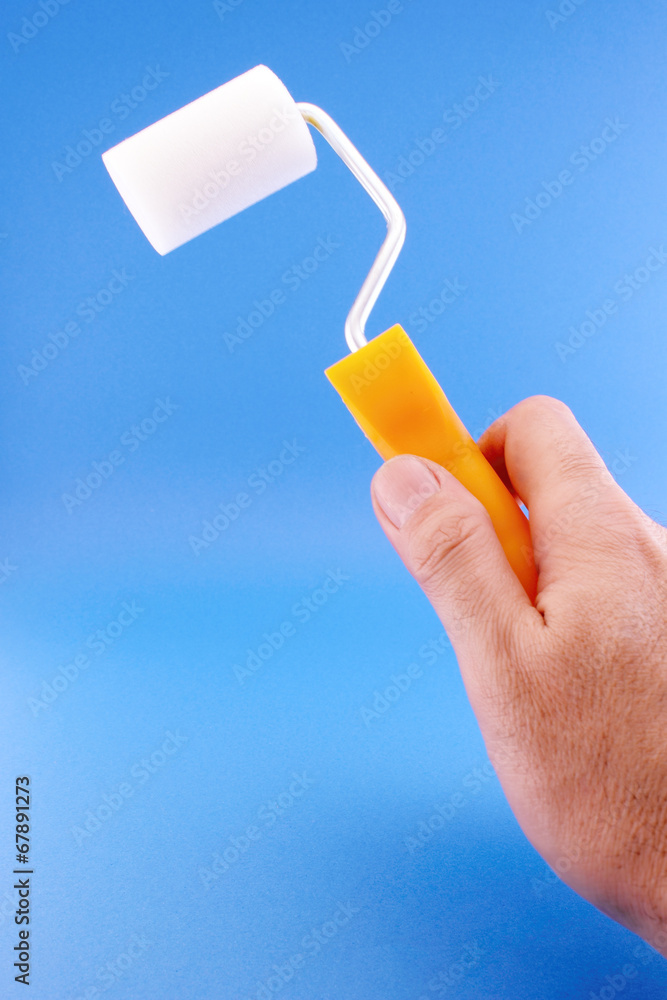 Hand with paint roller Hand with paint roller