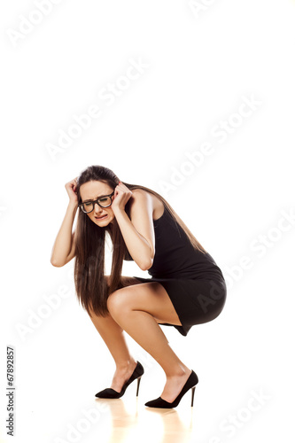 scared woman crouched with her hands in the defenses position