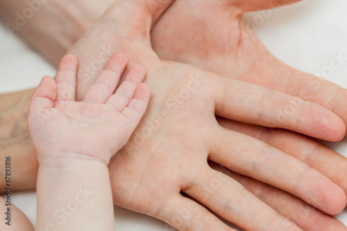Father and mother holding child's hand
