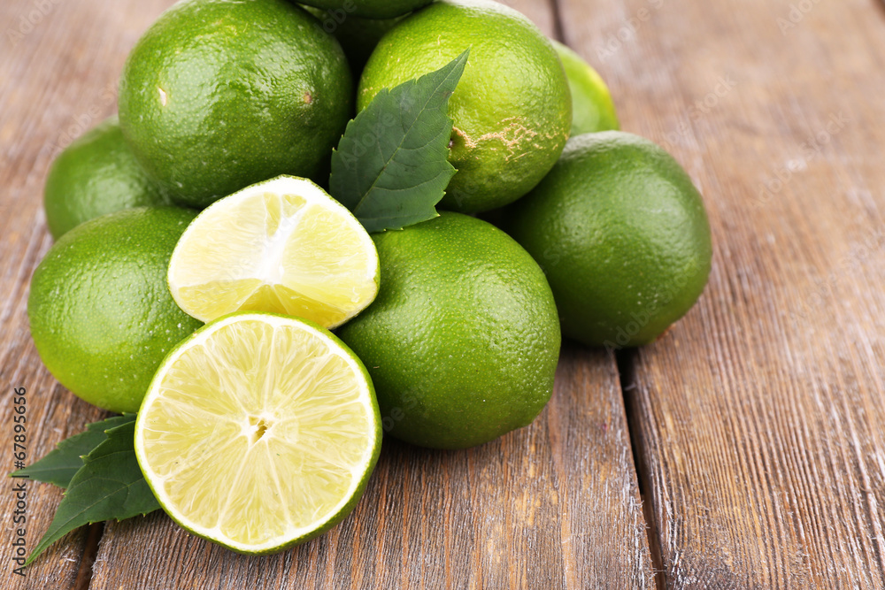 Fresh juicy limes on old wooden table Fresh juicy limes on old wooden table