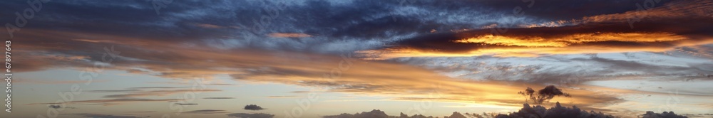 Sunlit clouds in bright sunrise or sunset banner sky