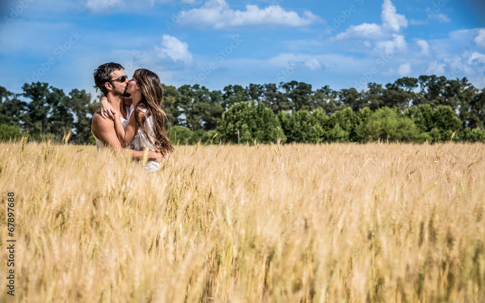 Couple in love kissing in argentinean countryside fields.