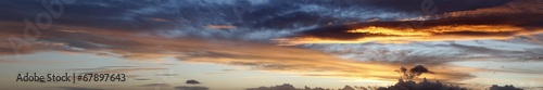 Sunlit clouds in bright sunrise or sunset banner sky