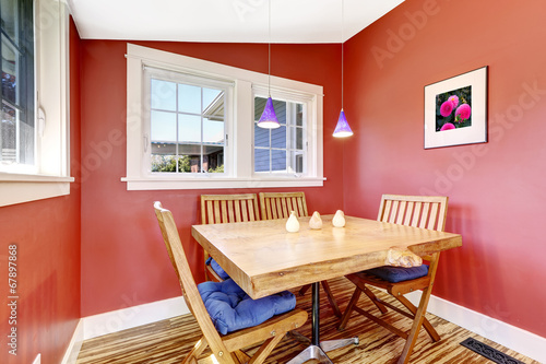 Bright red dining area with rustic table set