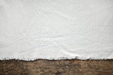 old white cotton tablecloth on wooden table