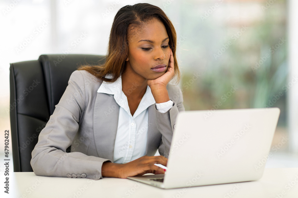 young african businesswoman looking at the laptop screen young african businesswoman looking at the laptop screen