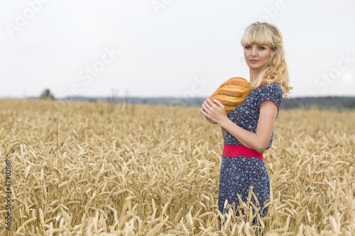 The happy woman holding bread