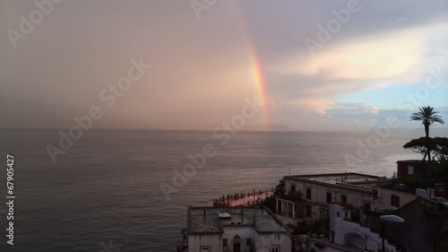 Time-lapse con tramonto ed arcobaleno photo