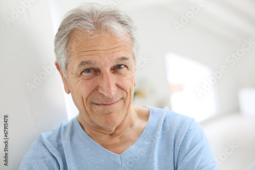 Portrait of smiling senior man with blue shirt