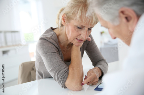 Senior woman seeing specialist for diagnostic