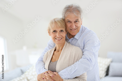 Loving senior couple looking at camera