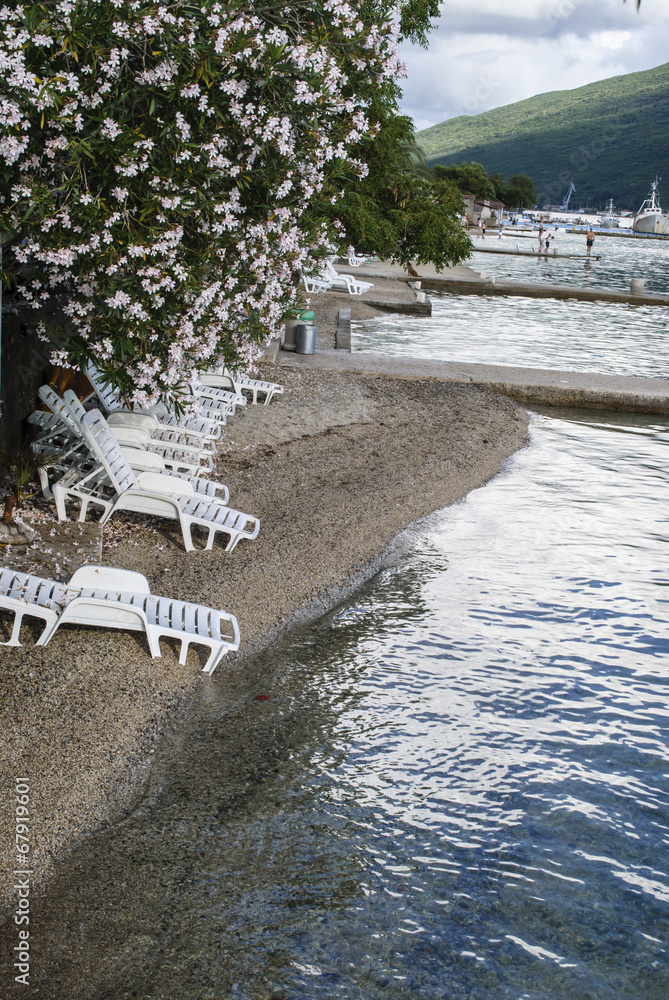 Fototapeta premium Deckchairs on small beach