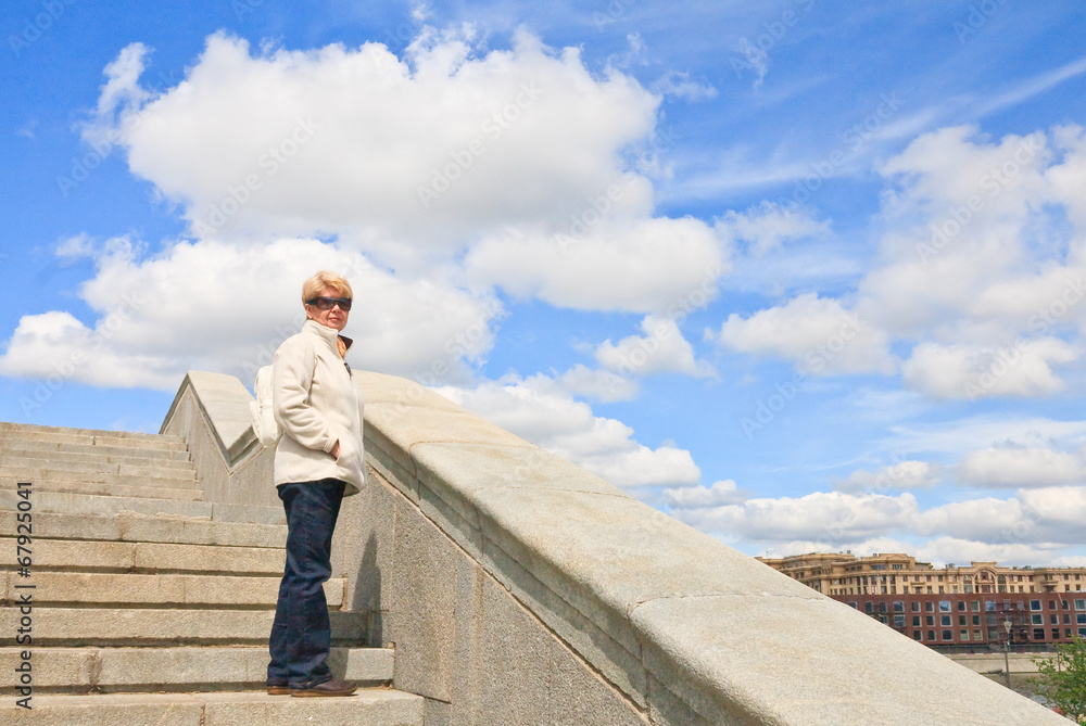 Portrait of a woman of retirement age on the stairs Portrait of a woman of retirement age on the stairs