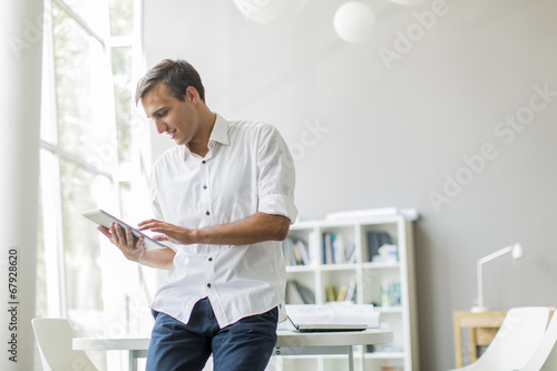 Young man with tablet in th...