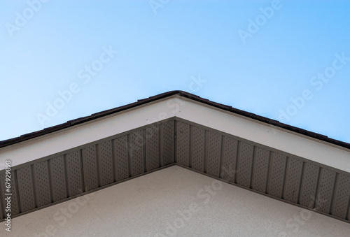 Top of house roof edge on clear sky.